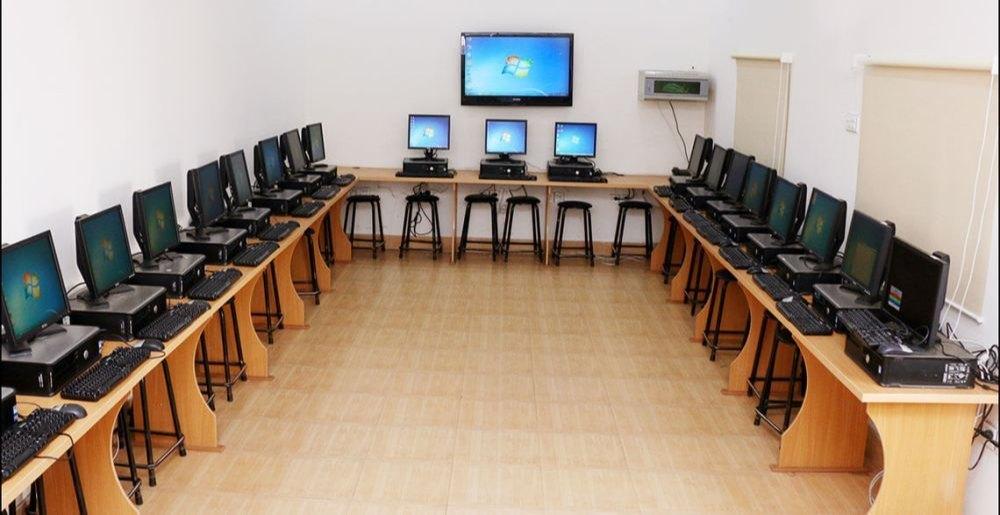 Modern computer lab with students learning at workstations